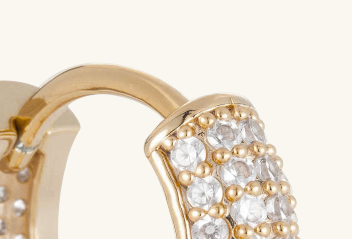 Close-up of BuzzBloom 14K gold diamond hoop earrings with real pavé-set diamonds