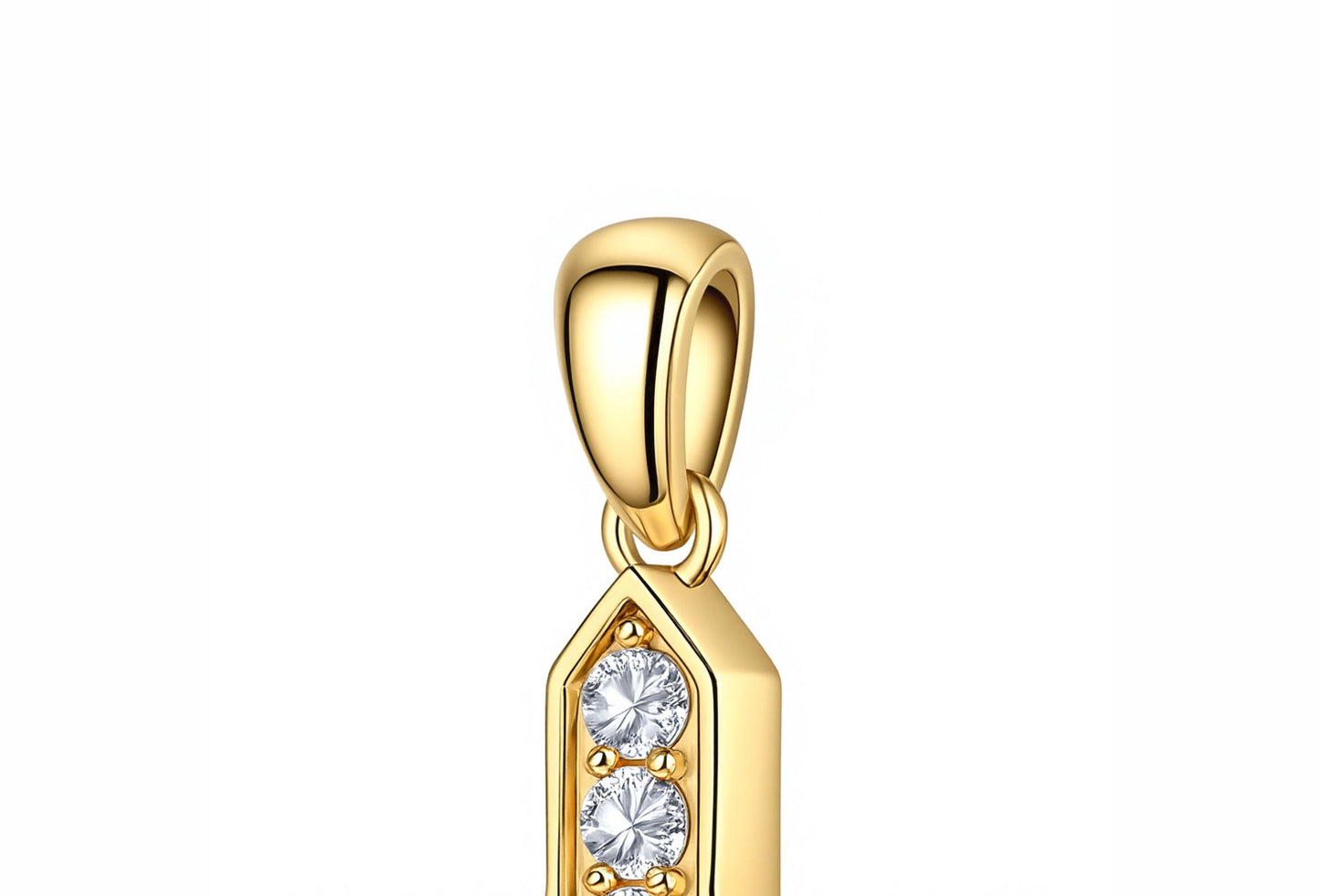 Macro shot of Buzzbloom 14K gold diamond cross pendant, highlighting craftsmanship and diamond clarity.