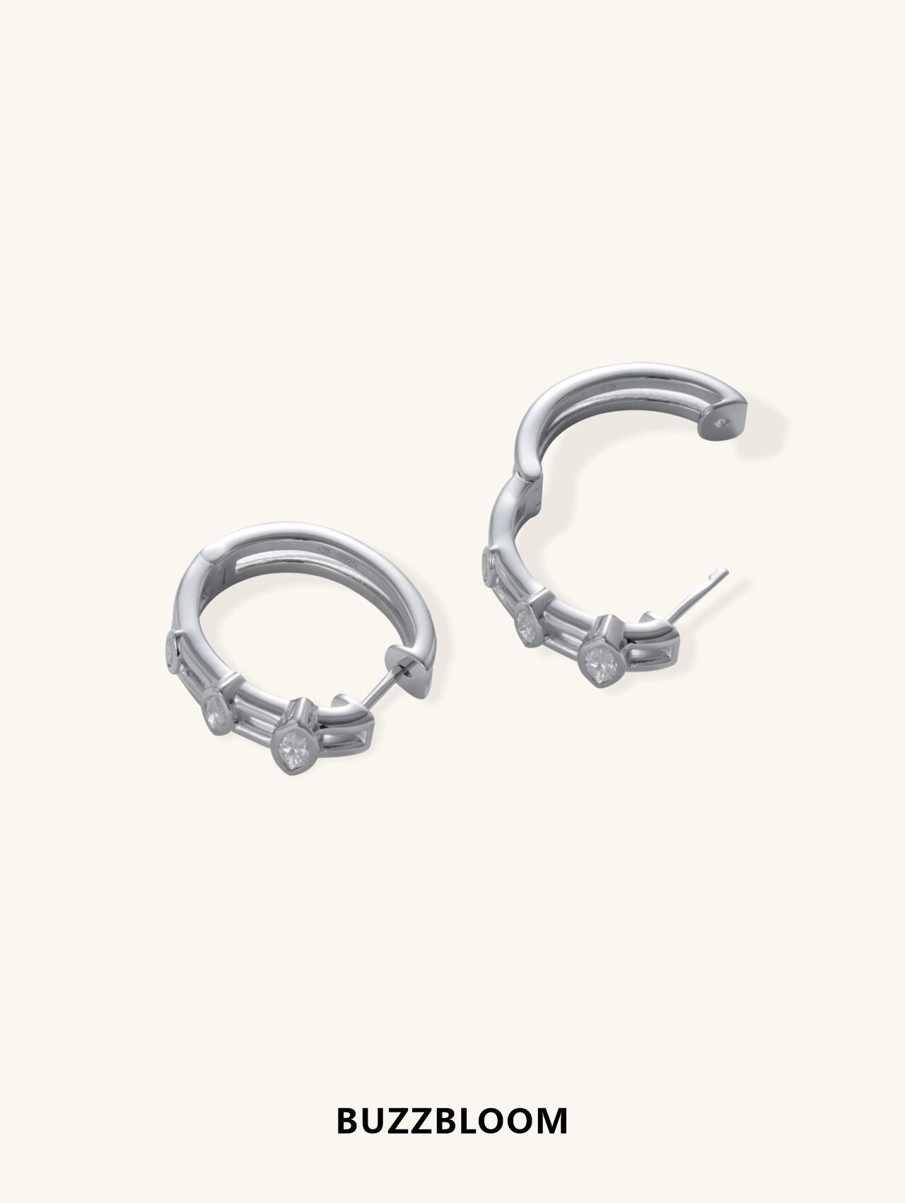 BuzzBloom 14K white gold hoop earrings featuring marquise-cut bezel-set diamonds, angled side view.