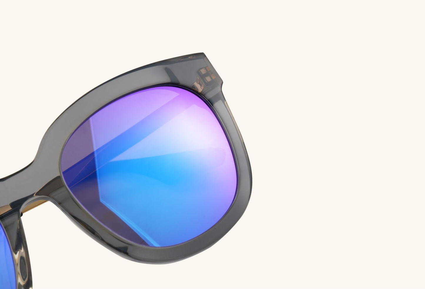 Close-up detail of aerospace-grade nylon sunglasses hinge and gold temple design
