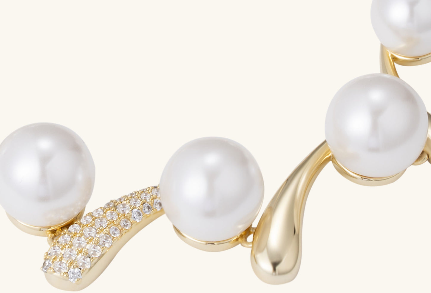 BuzzBloom Australian White Shell Pearl 14K Diamond Bracelet draped on cream velvet roll, bathed in soft golden light.