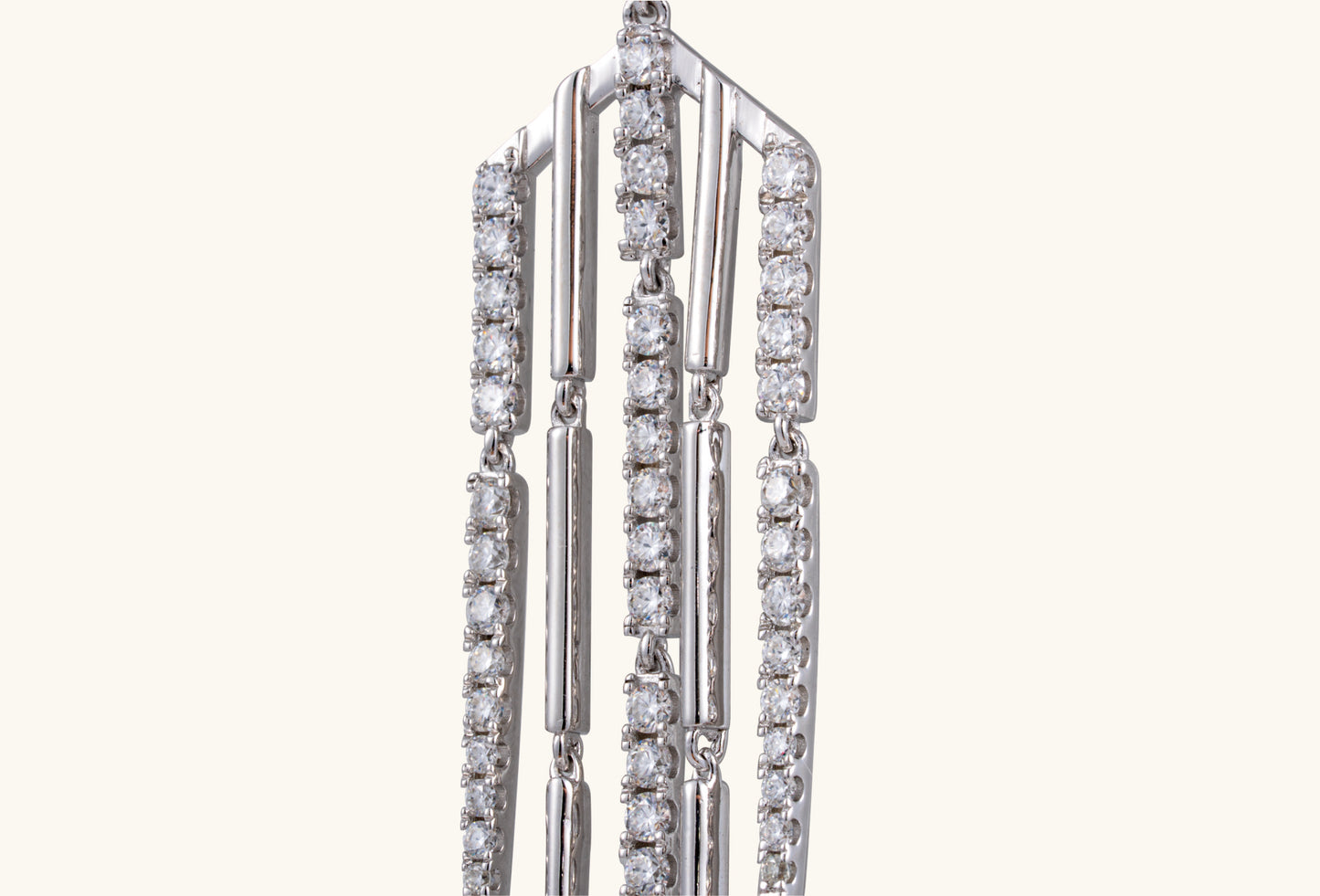BuzzBloom statement silver tassel earrings on neutral background