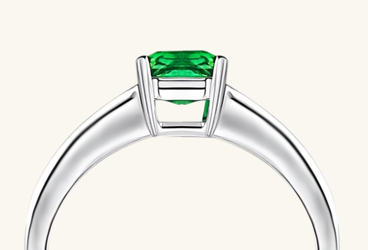 Macro shot showing precision and facet detail of emerald center and baguettes