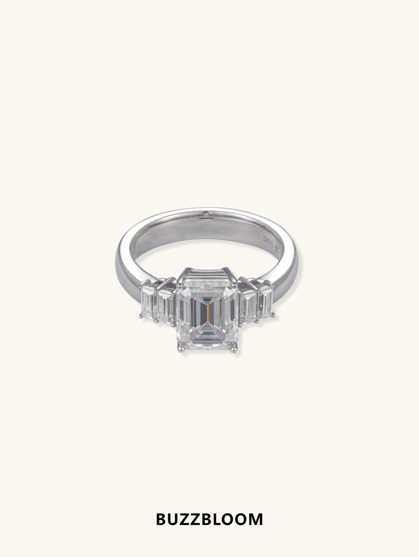BuzzBloom emerald cut diamond ring with baguette side stones, front view.