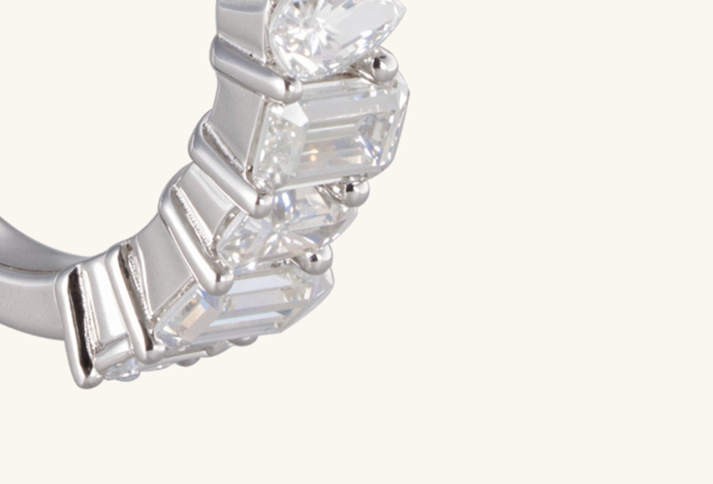 Close-up of five step-cut diamonds on BuzzBloom emerald cut multi-stone ring in 14K white gold