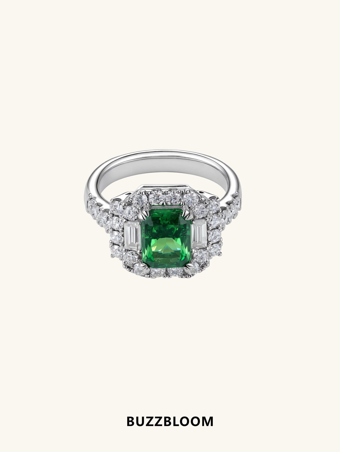 BuzzBloom emerald halo ring front view with baguette and round accents