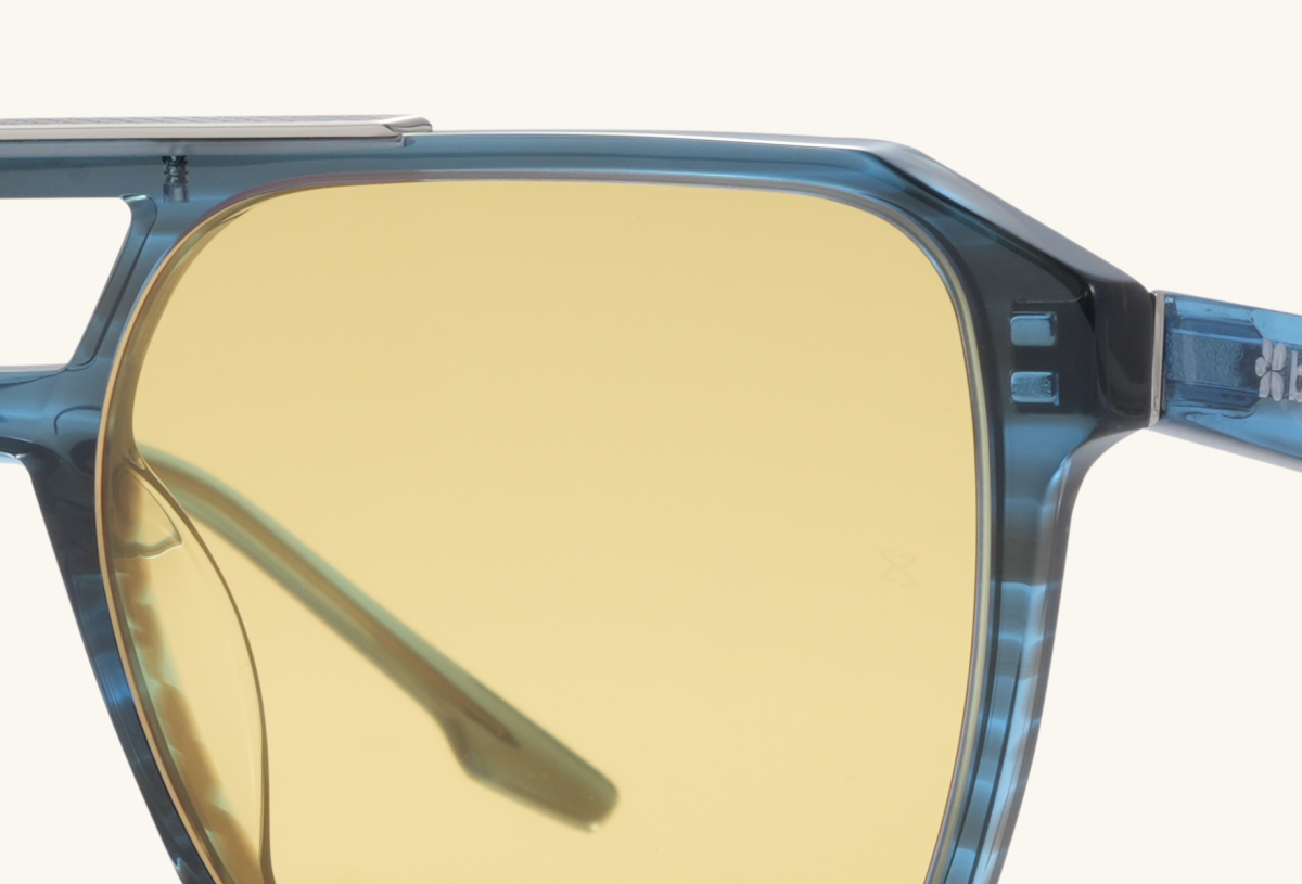 Close-up detail of BuzzBloom square aviator sunglasses showing temple and hinge.