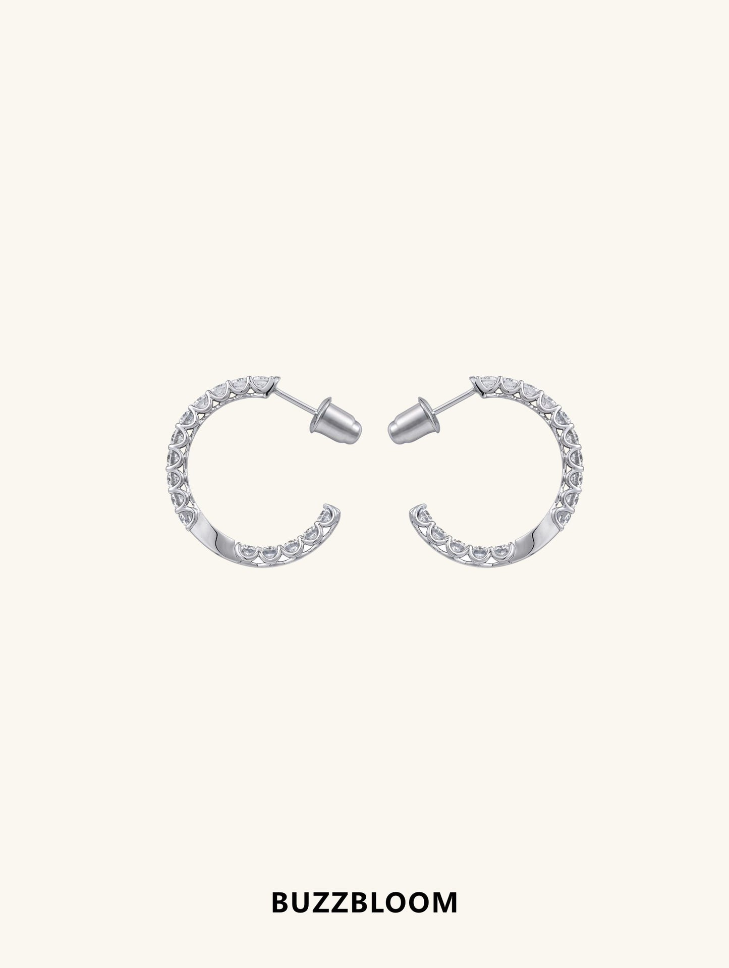 Front view of BuzzBloom sterling silver half-hoop earrings with moissanite.