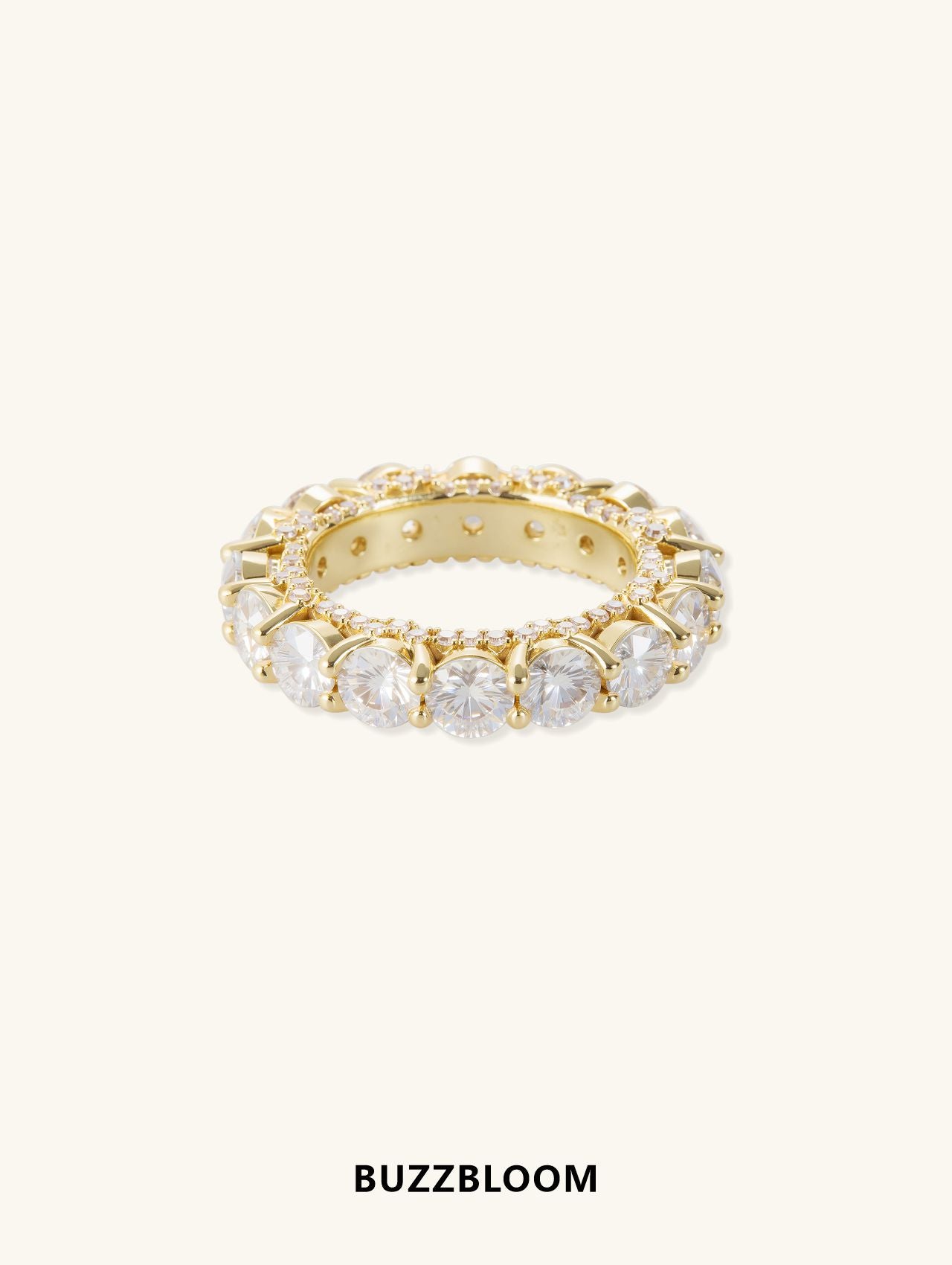 BuzzBloom prong-set full-circle diamond eternity ring in 14K yellow gold, angled view showcasing large round diamonds held in prong settings around the band.