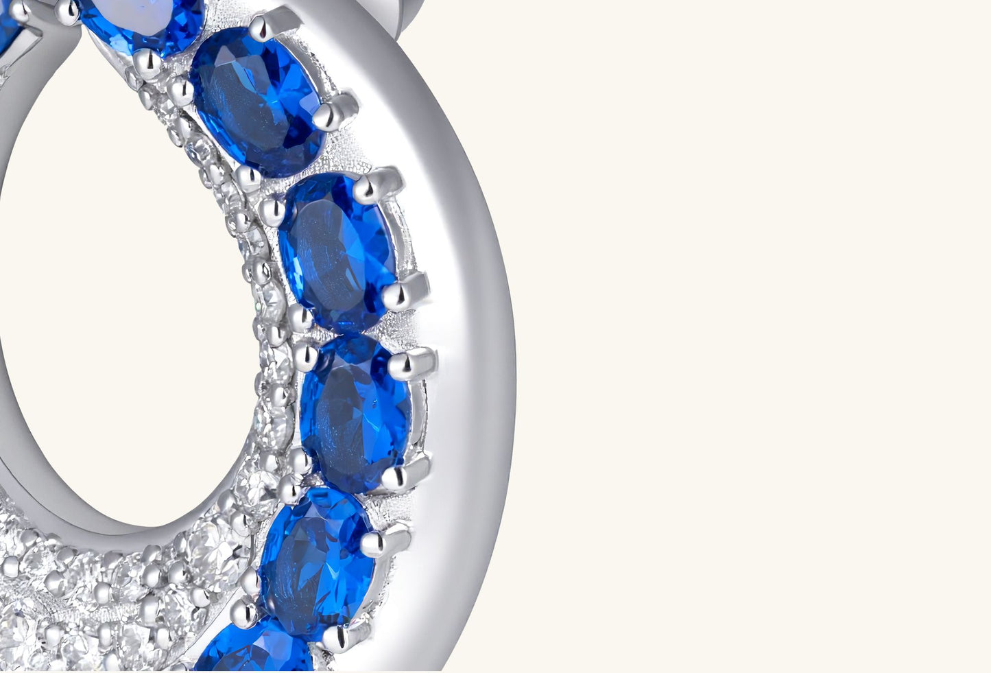 Close-up of BuzzBloom sapphire earrings post and gemstone prong setting