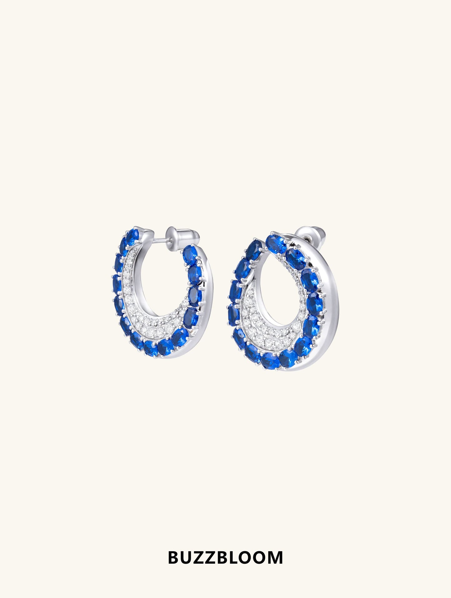Side angle of BuzzBloom sapphire hoop earrings with gemstone detailing