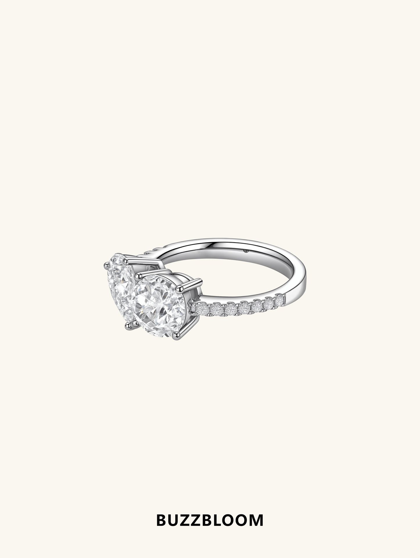 Side profile of BuzzBloom two-stone engagement ring showing pavé band